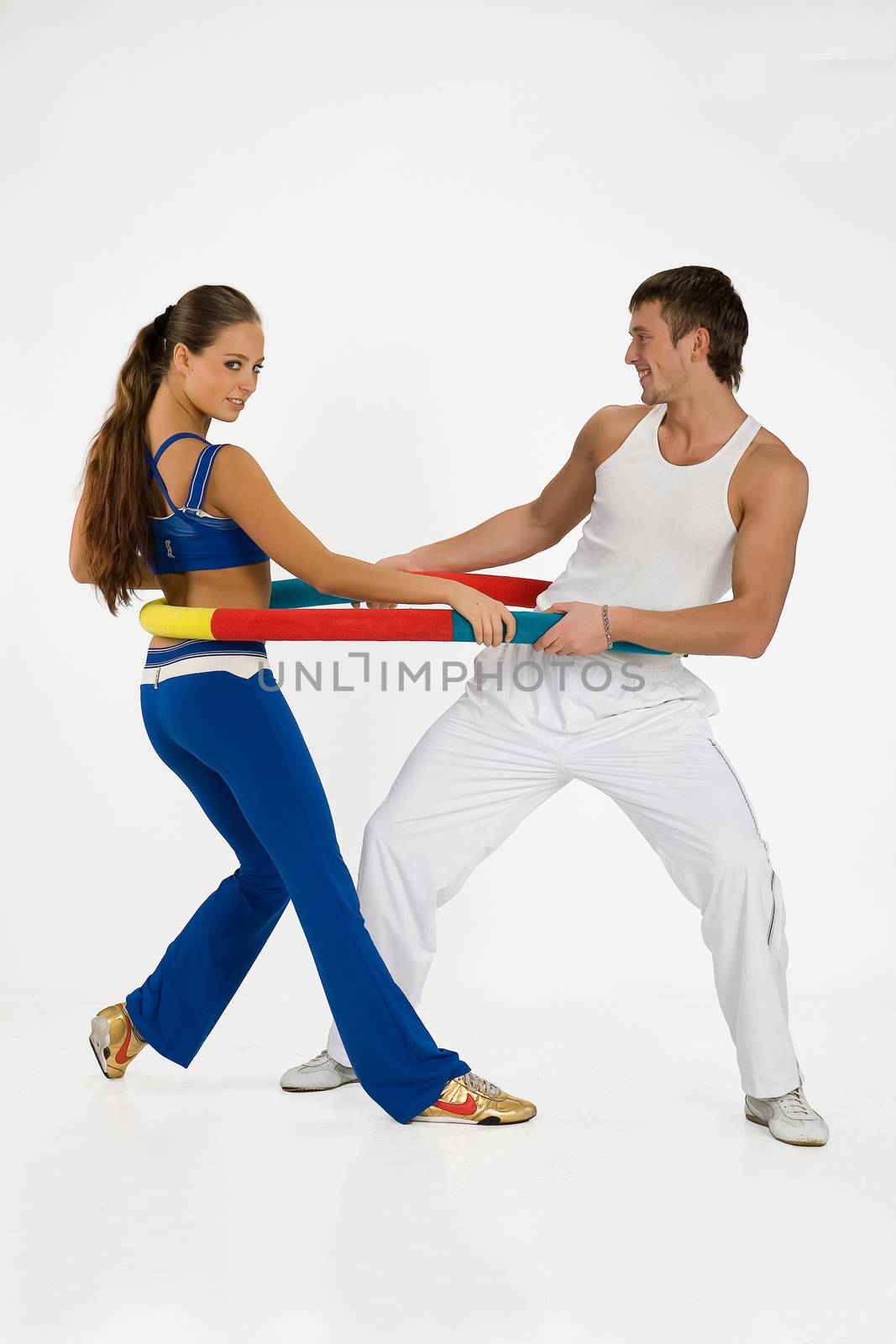 Young woman and man with the training device on isolated background