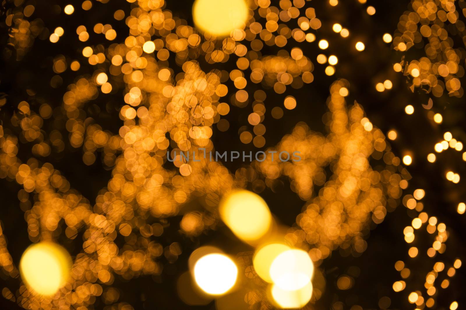 Close up of large golden bokeh shapes.