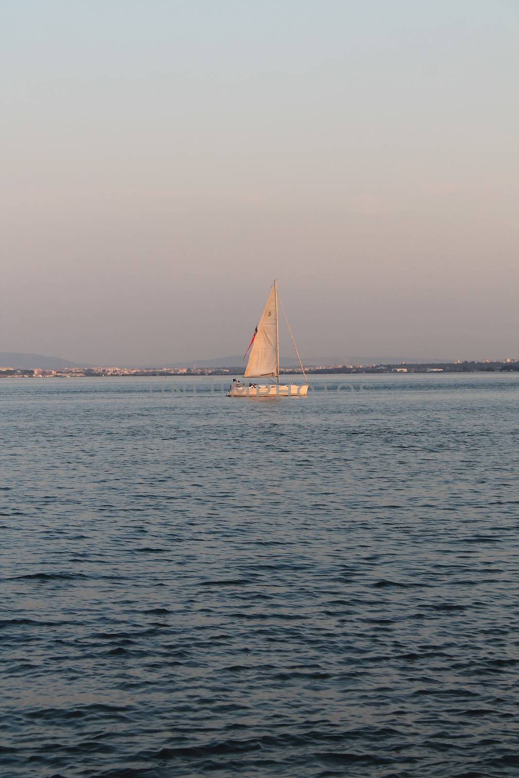 sailboat in the middle of the sea by lovecomunication