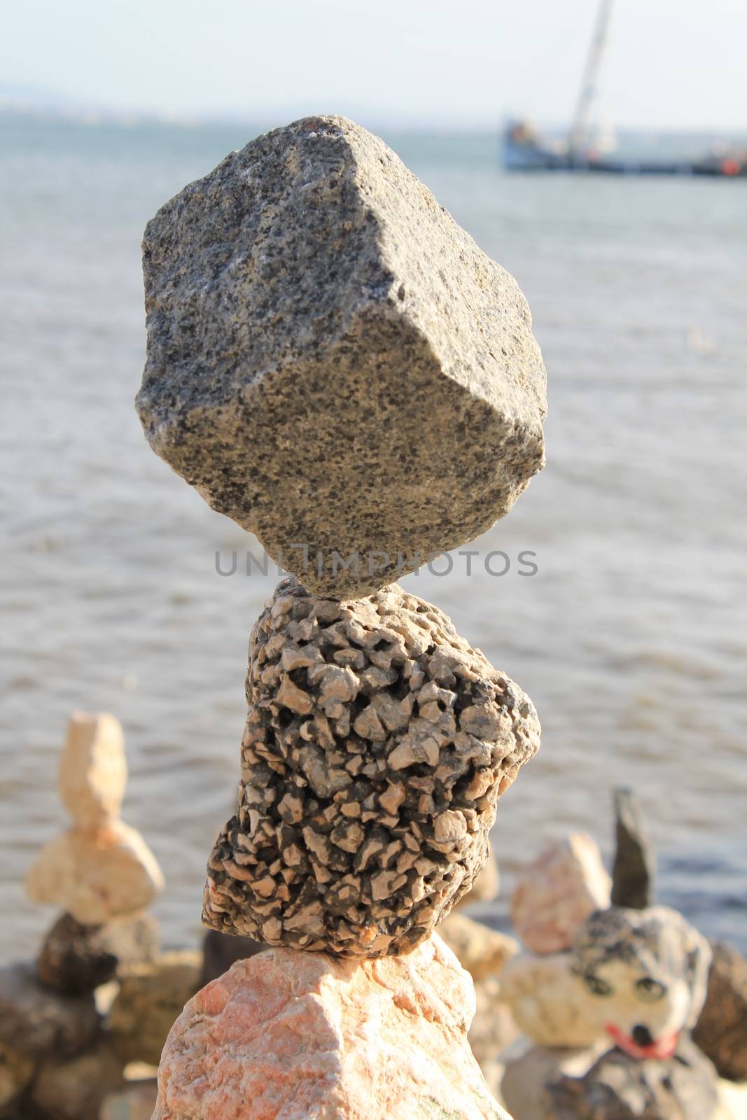 stones balanced on the seashore by lovecomunication