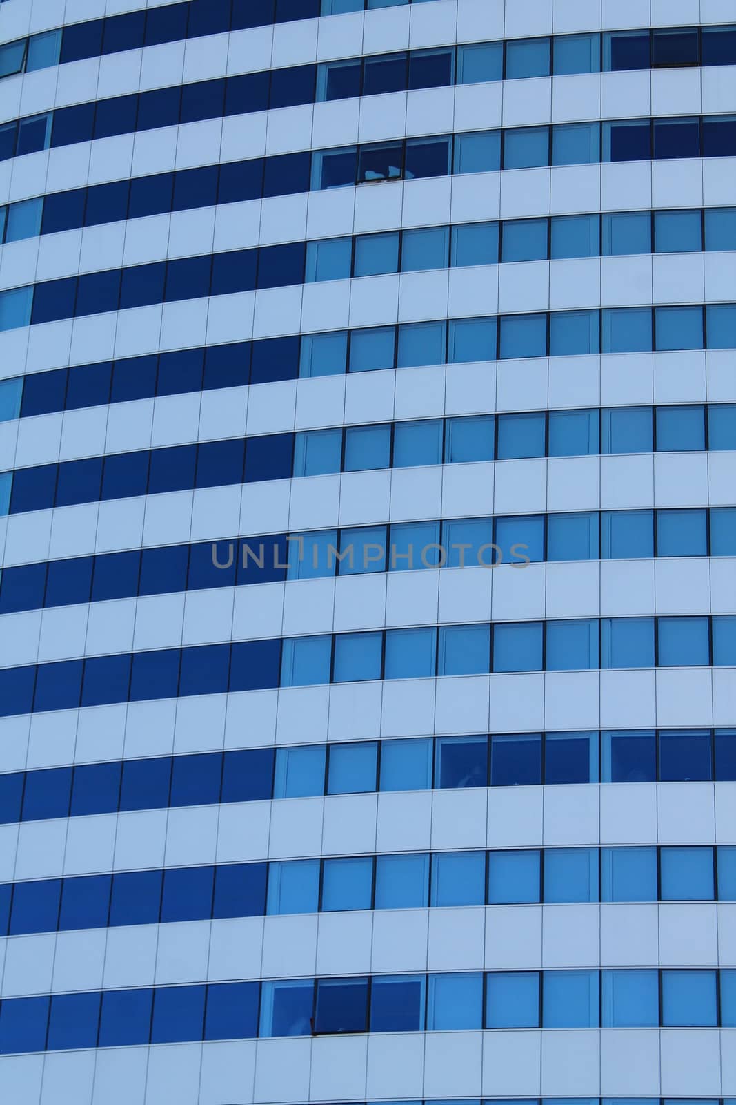 White architectural structure with blue sky background with blue windows