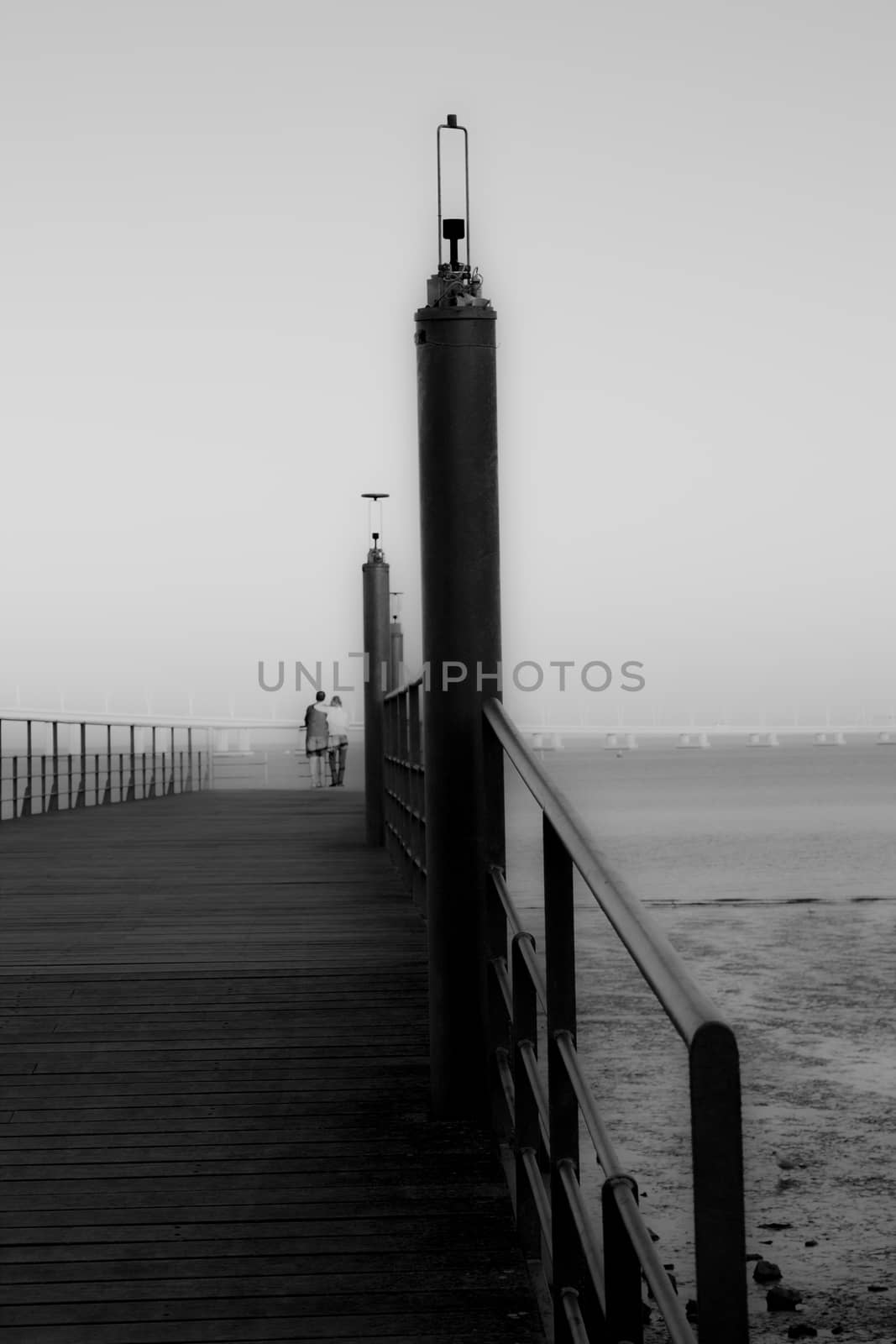 Small bridge on the river in black and white with couple