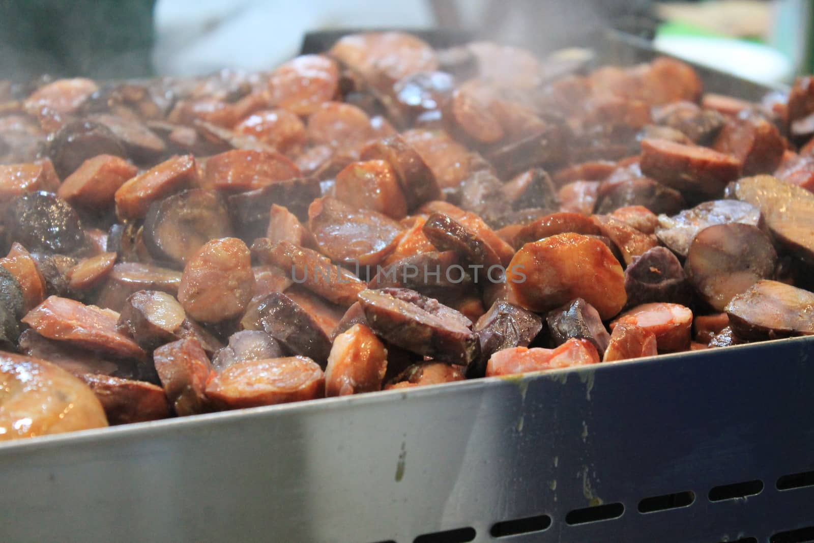 roast meat on plate with sausages and steaks