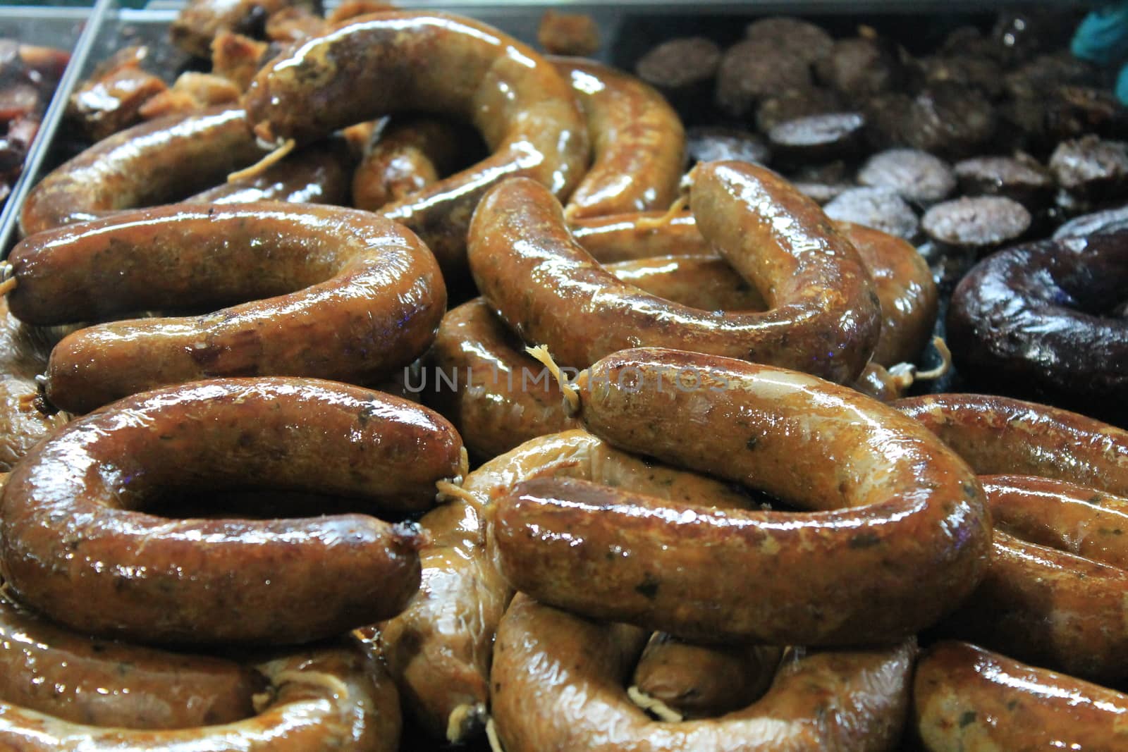 roast meat on plate with sausages and steaks