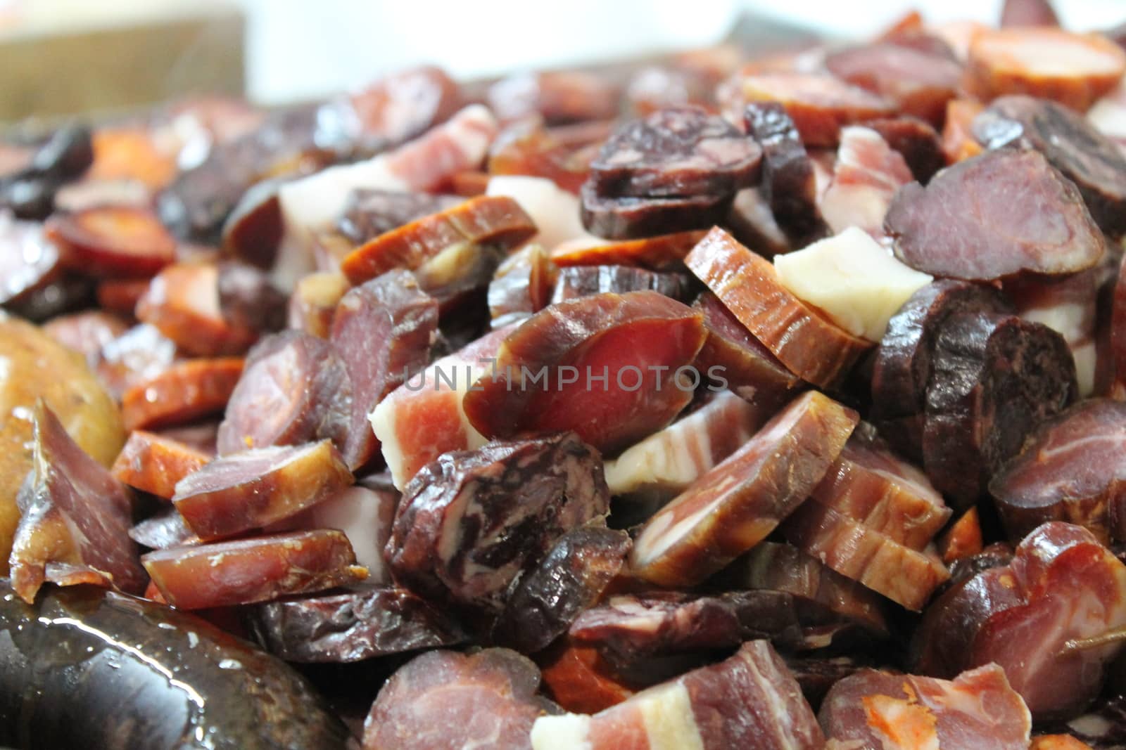 roast meat on plate with sausages and steaks