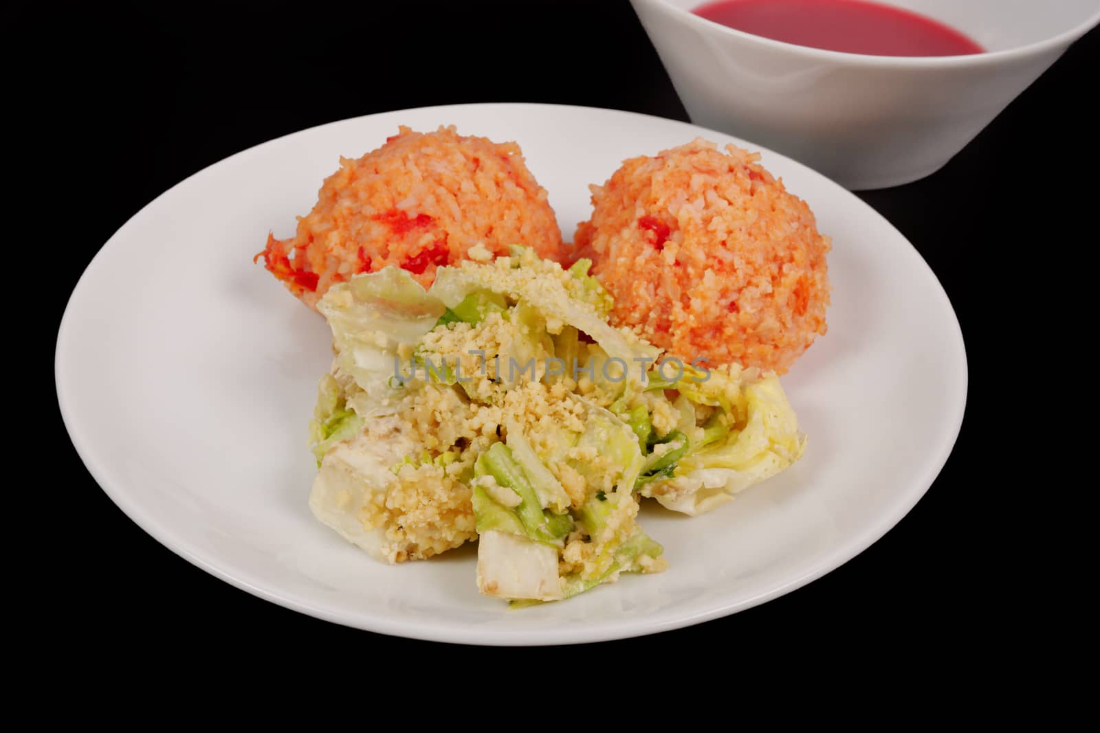 Tomato rice and salad on a black background