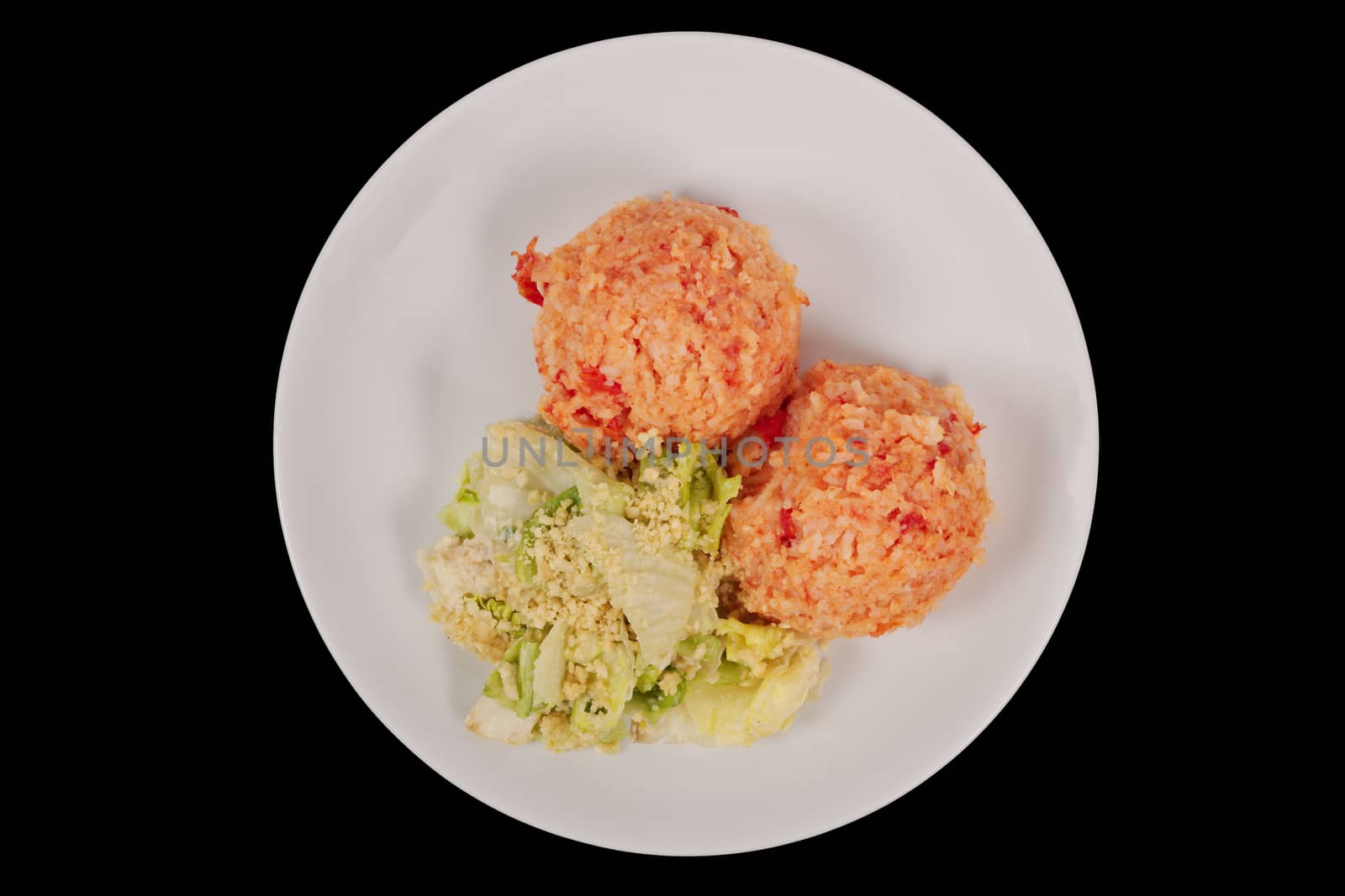 Tomato rice and salad on a black background