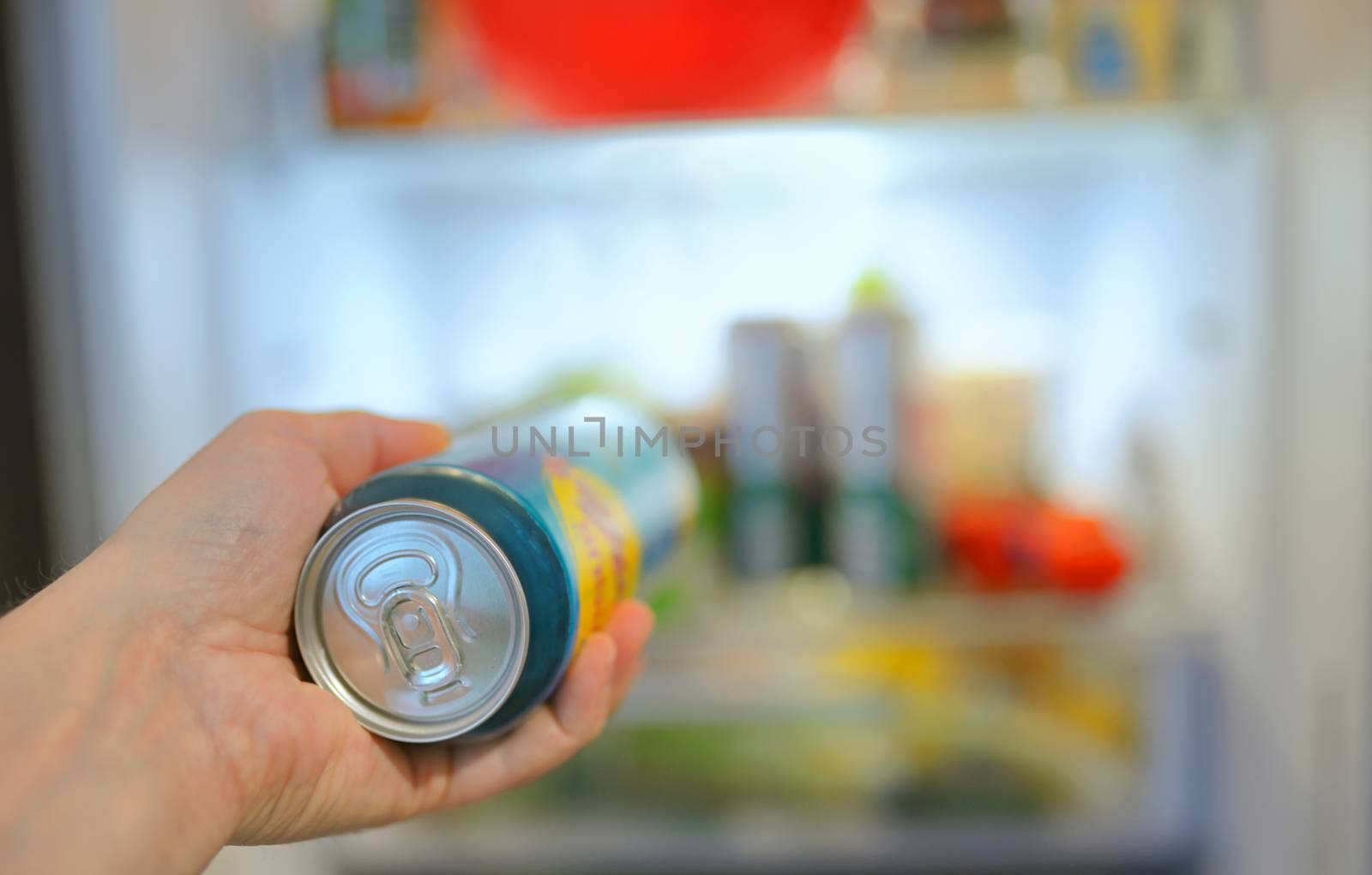 Man taking beer can from fridge