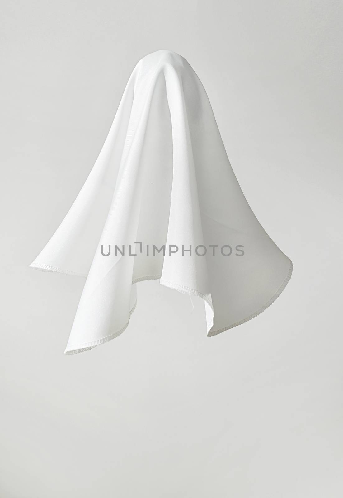White fabric in shape a ghost on white background