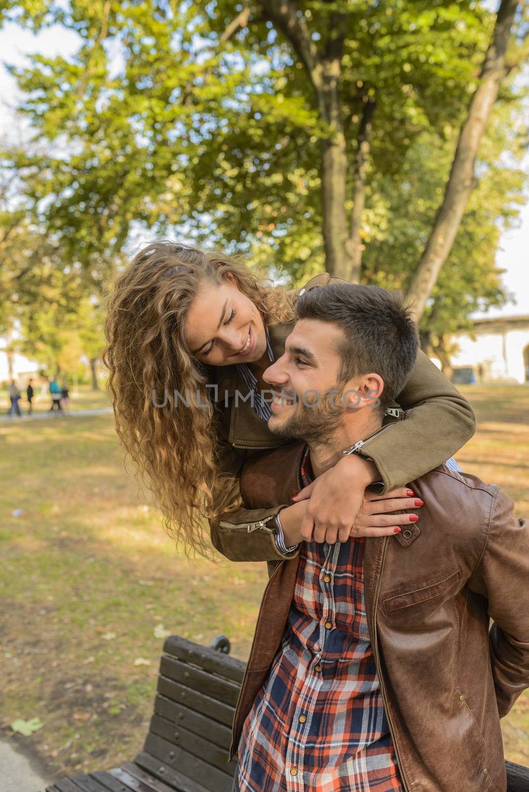 Beautiful long haired girl hugging her boyfriend by VeraAgency