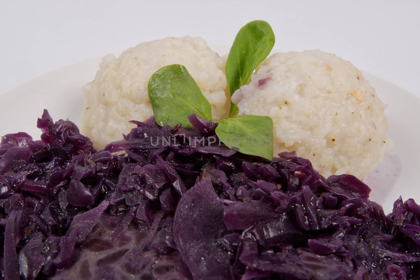 Tempeh with red cabbage and sorghum on a white background