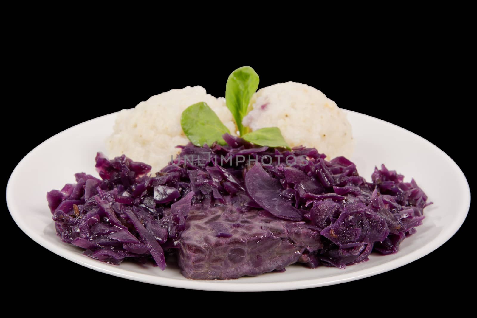Tempeh with red cabbage and sorghum on a black background
