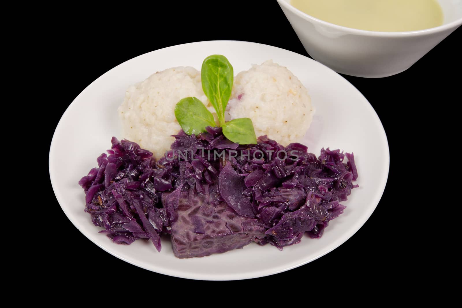 Tempeh with red cabbage and sorghum on a black background