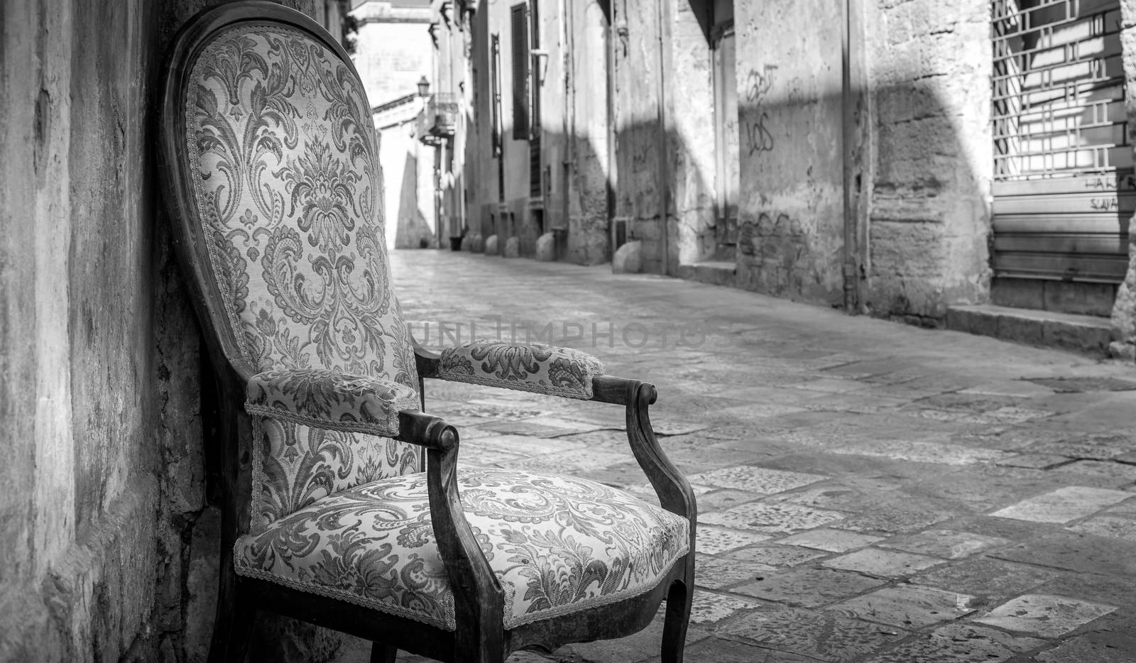 Old chair in a traditional street of Lecce, Italy. by Perseomedusa