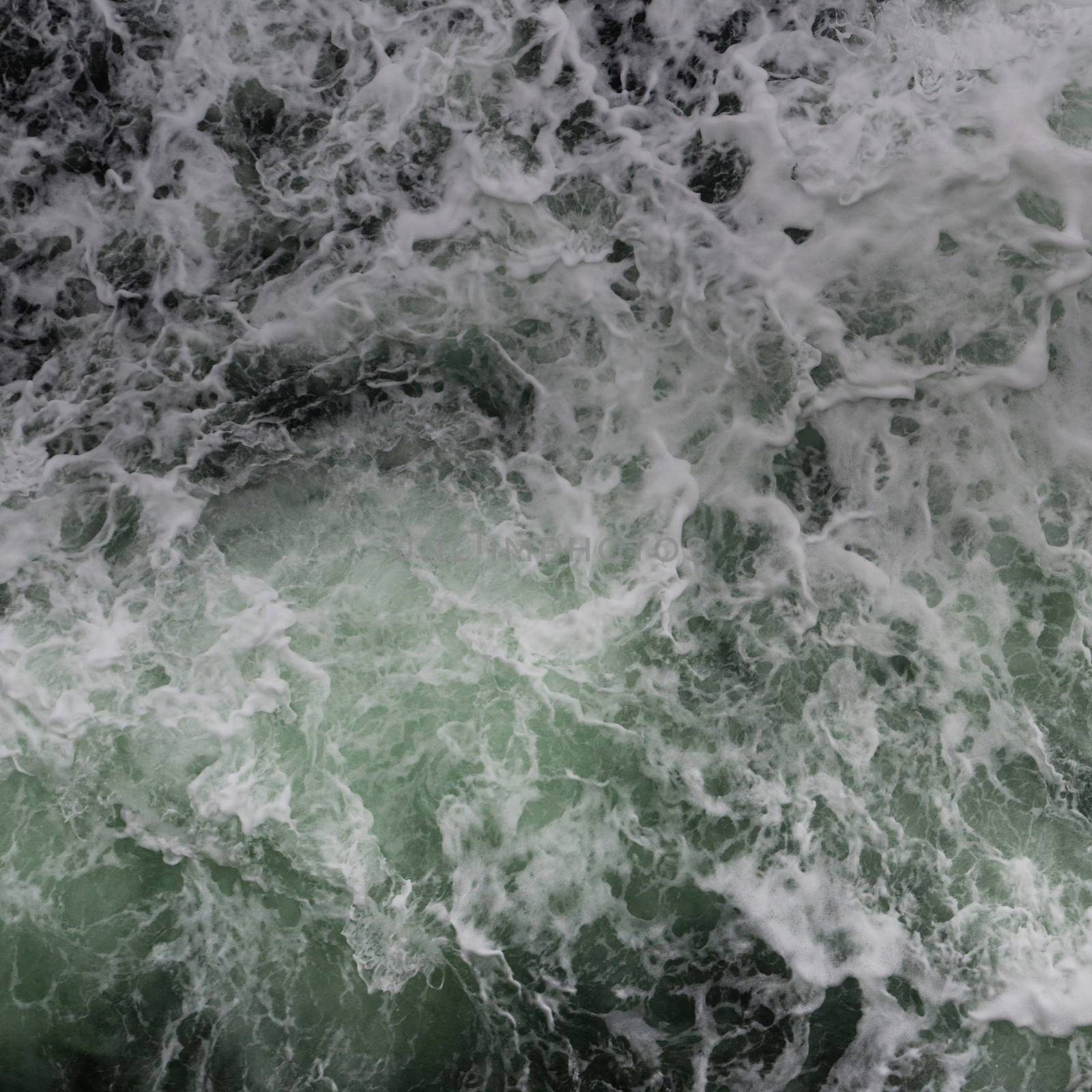 Big water splash seen from above a boat