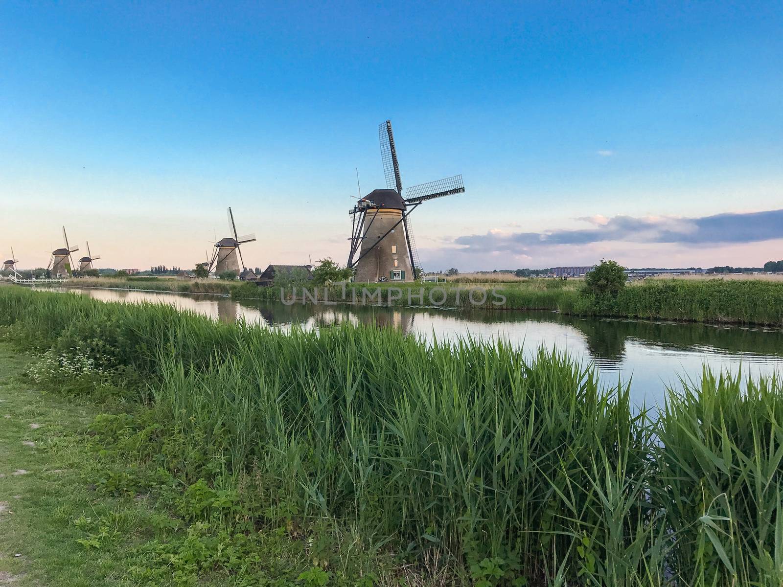 Beautiful dutch windmill landscape at the famous Kinderdijk canals, UNESCO world heritage site