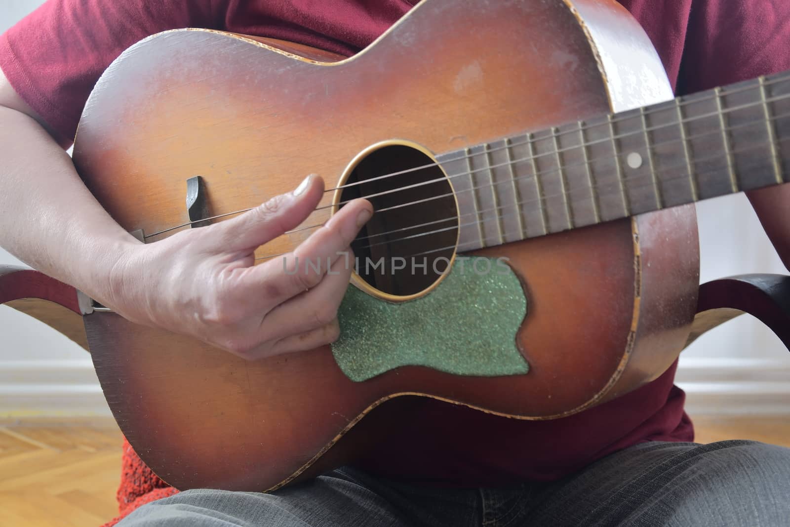 Closeup of man's hands playing acoustic guitar. Musical concept.