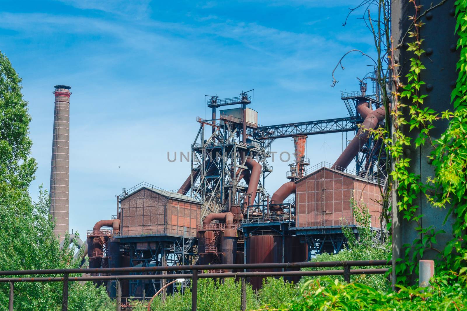General view of an industrial plant refinery, consisting of pipes and towers of heavy industry.