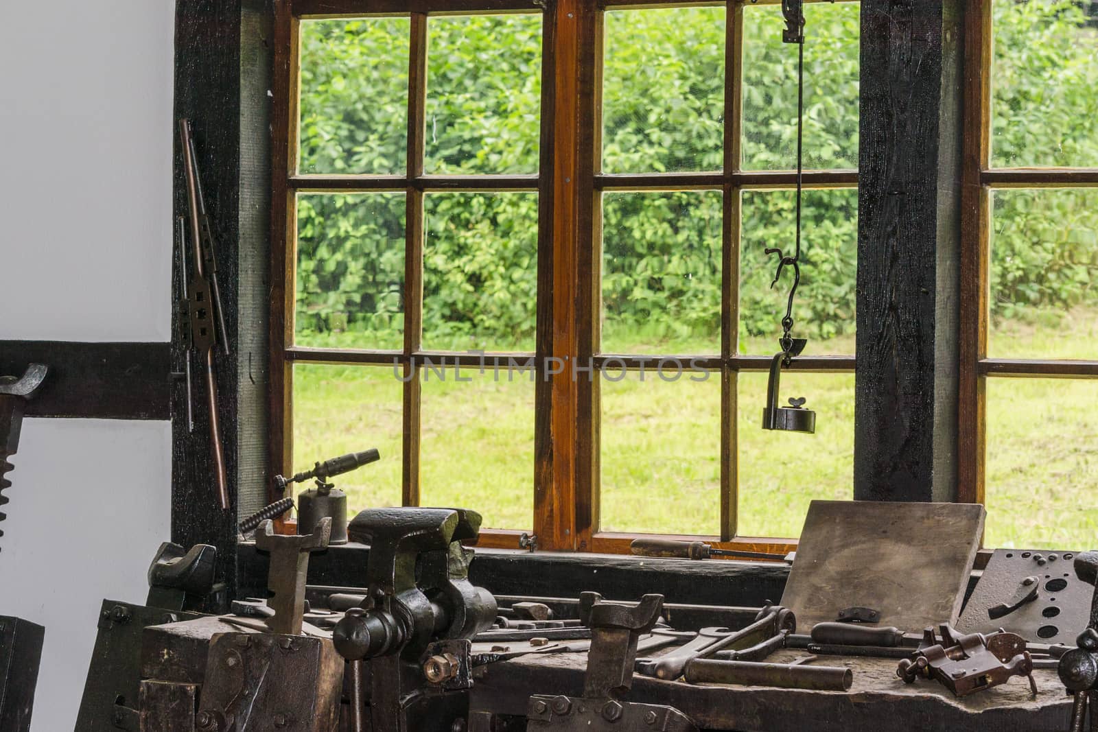 Old workbench with various tools and machines.