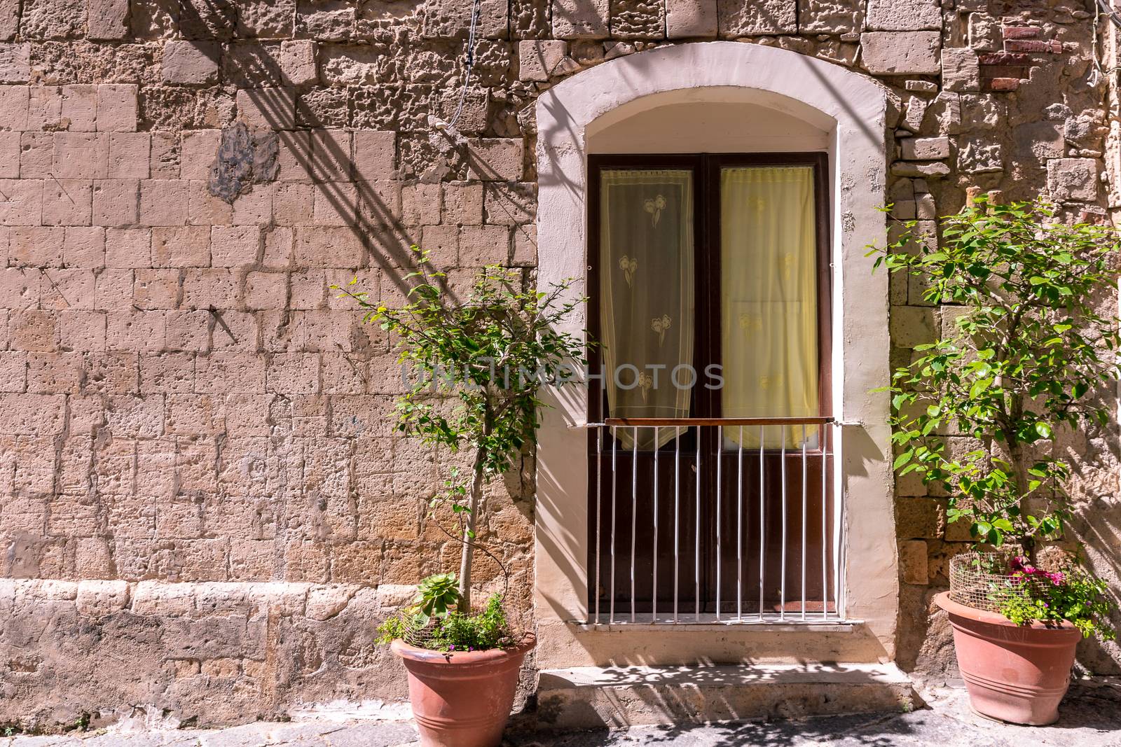 the window with the railing on stone wall, for background