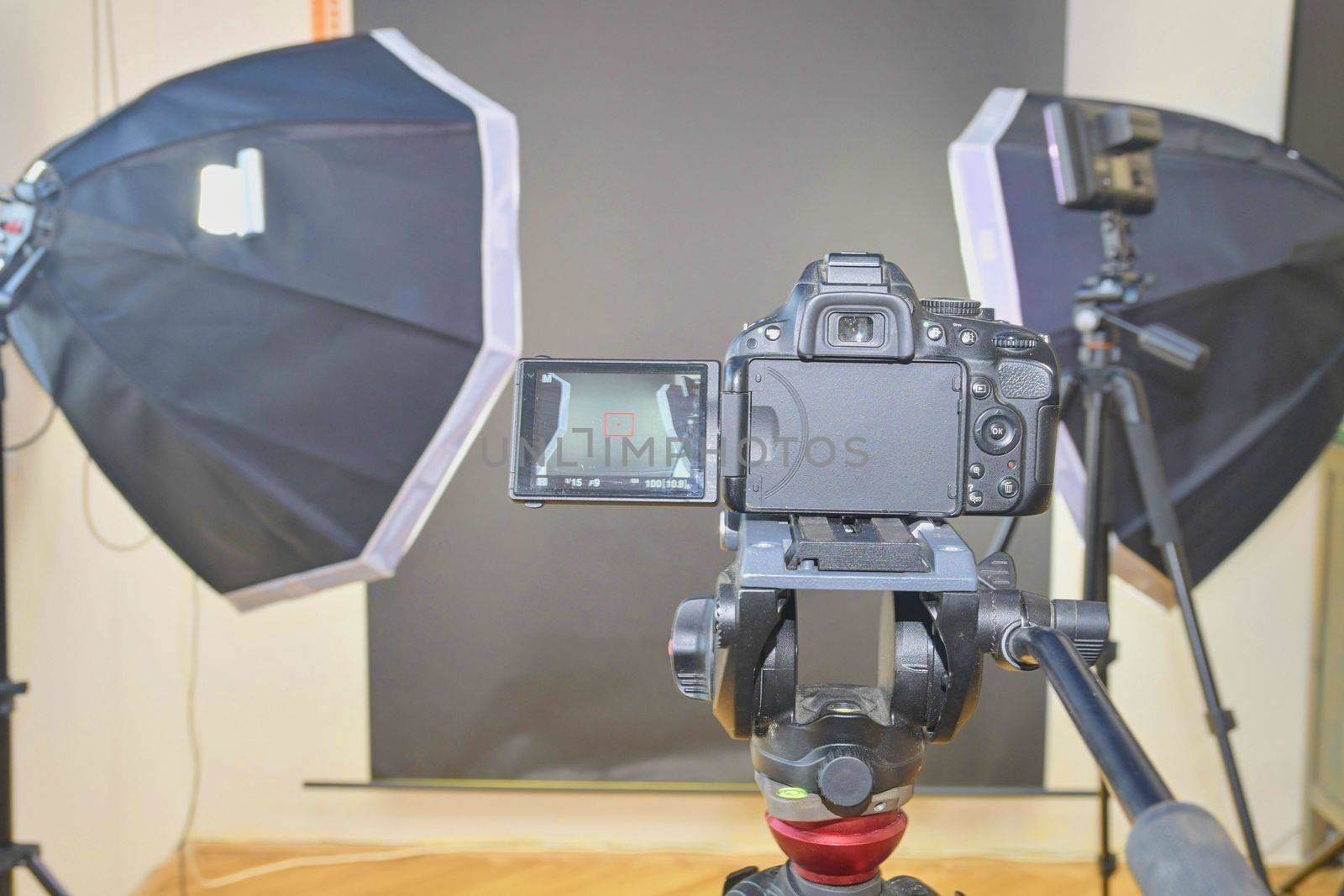 Empty photo studio with lighting equipment. Professional camera with picture of photo studio. 