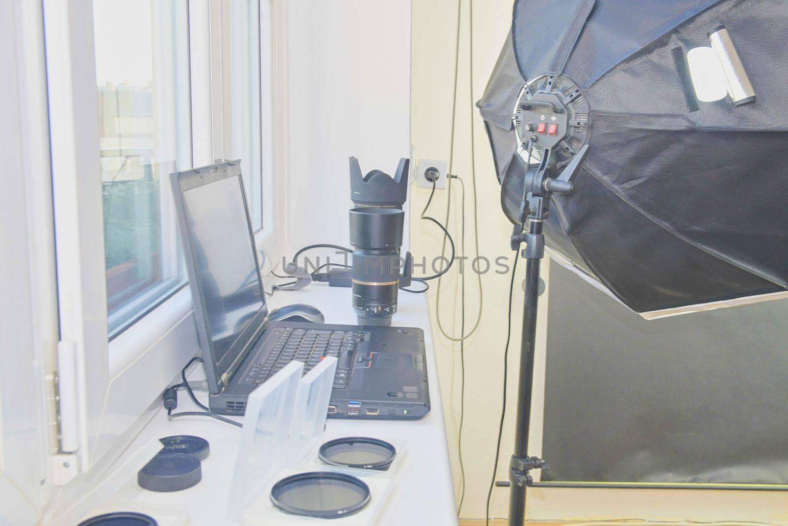 Empty photo studio with lighting equipment. Lenses and filters for photographer.