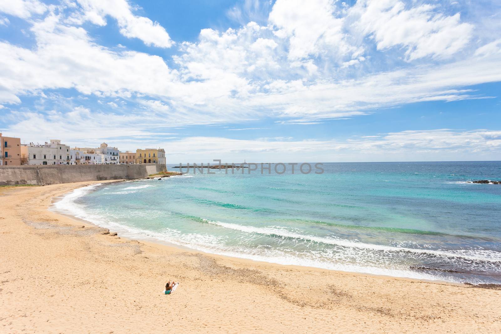 Gallipoli, Apulia - A woman enjoying the silence at the beach of by tagstiles.com