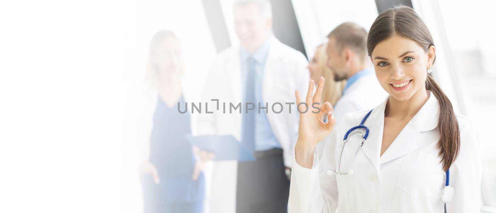 Young female doctor in front of medical team in hospital