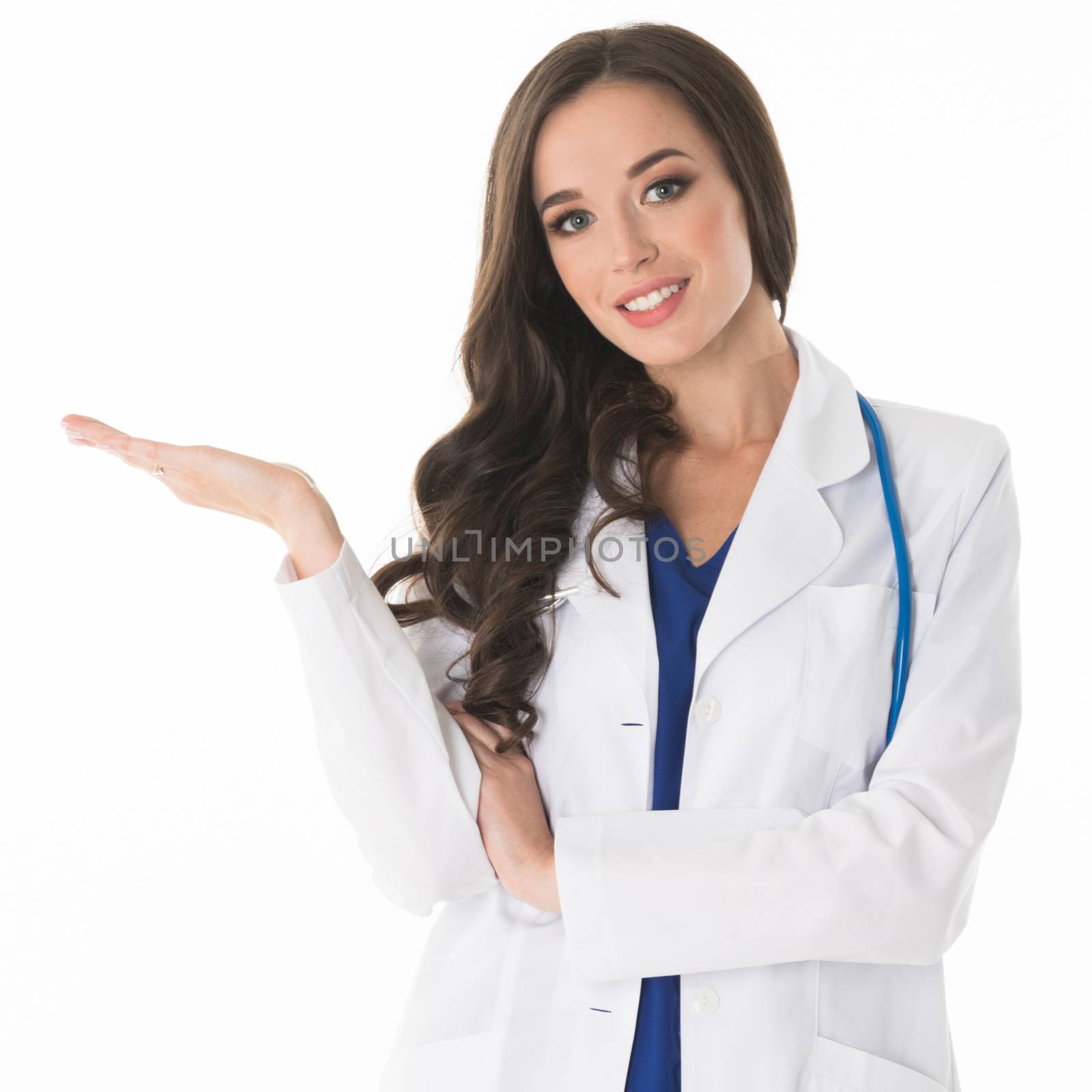 Happy smiling young beautiful female doctor showing blank area for sign or copyspace, isolated on white background