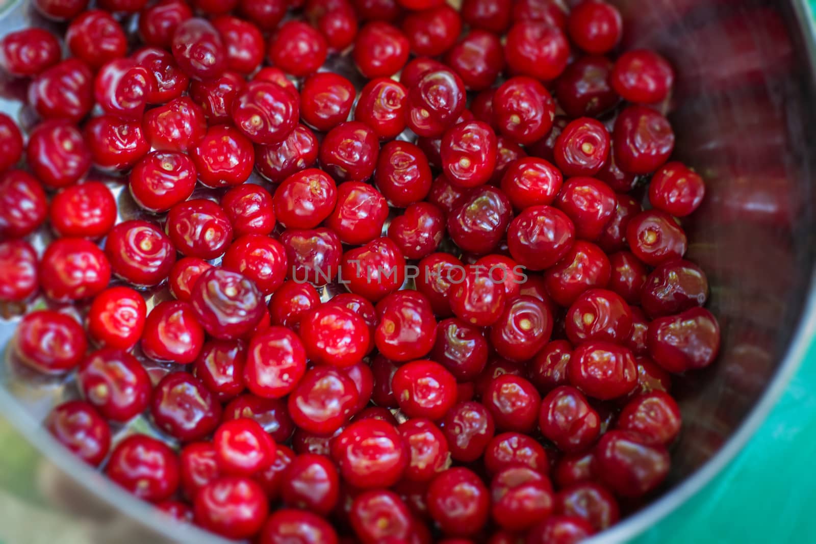 Sweet red Cherry in Bowl on Table top close-up view