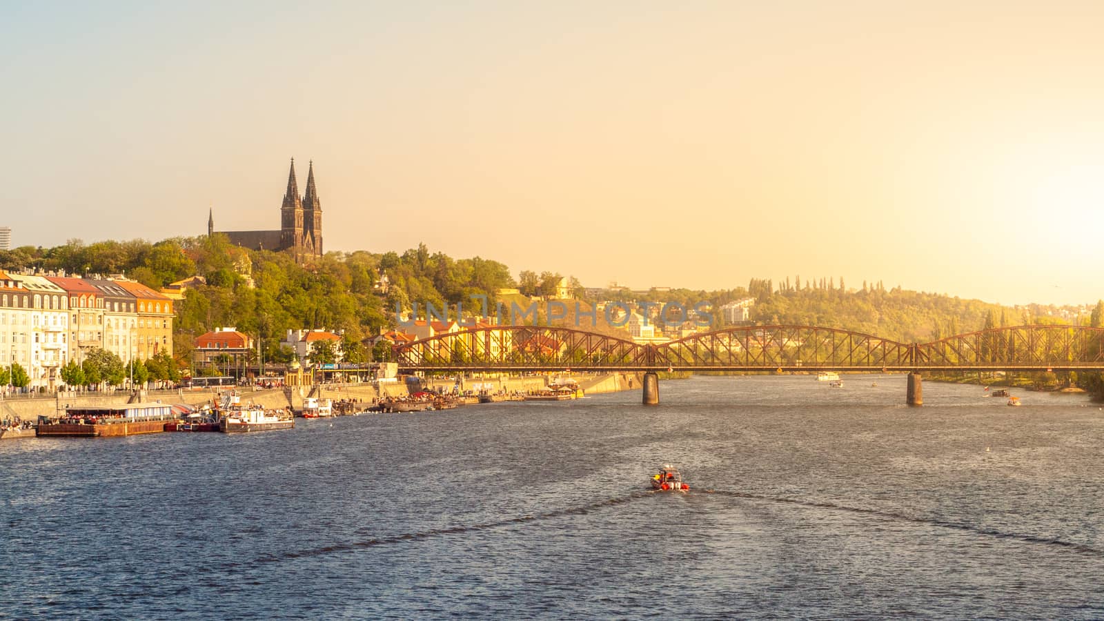 Vysehrad and Railroad Bridge over Vltava on sunny summer evening with sunset. Prague cityscape, Czech Republic.