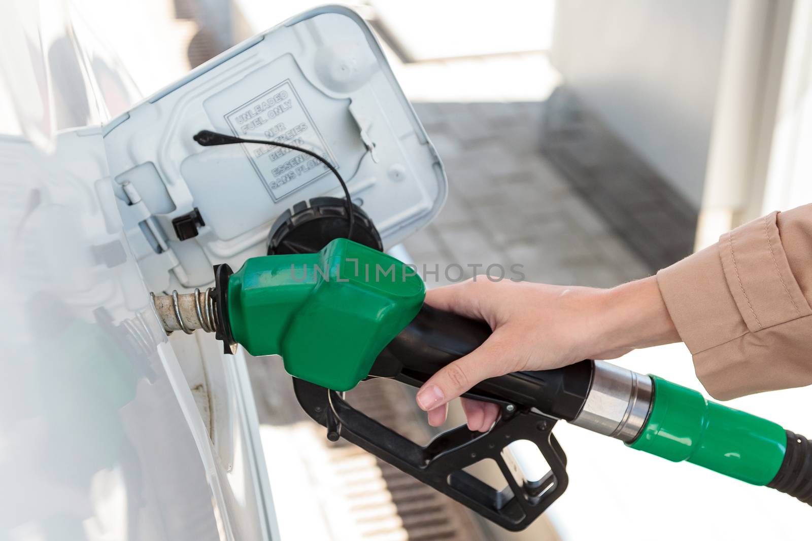 Woman at the gas pump station by Nobilior