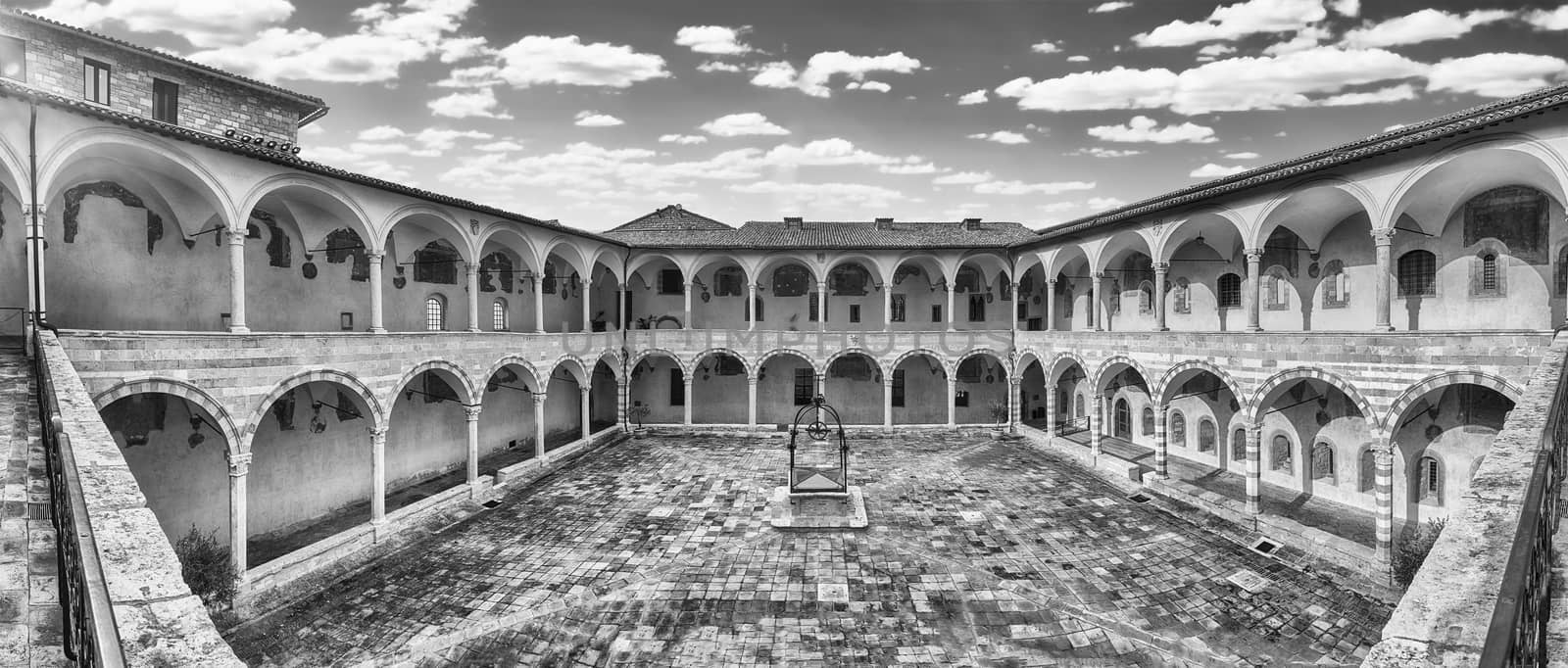 Panoramic view with the scenic courtyard in the friary of the Basilica of Saint Francis, Assisi, Italy. UNESCO World Heritage Site since 2000