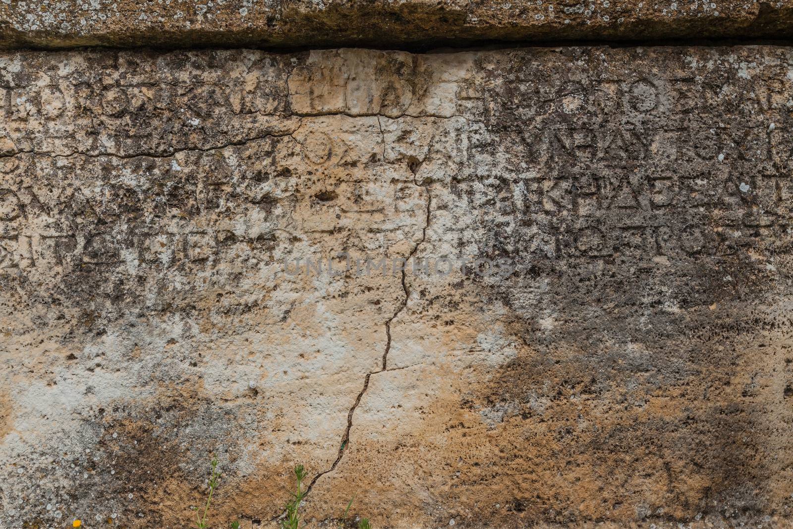 Texture of stone plate with inscriptions in ancient city Hierapolis near Pamukkale, Turkey