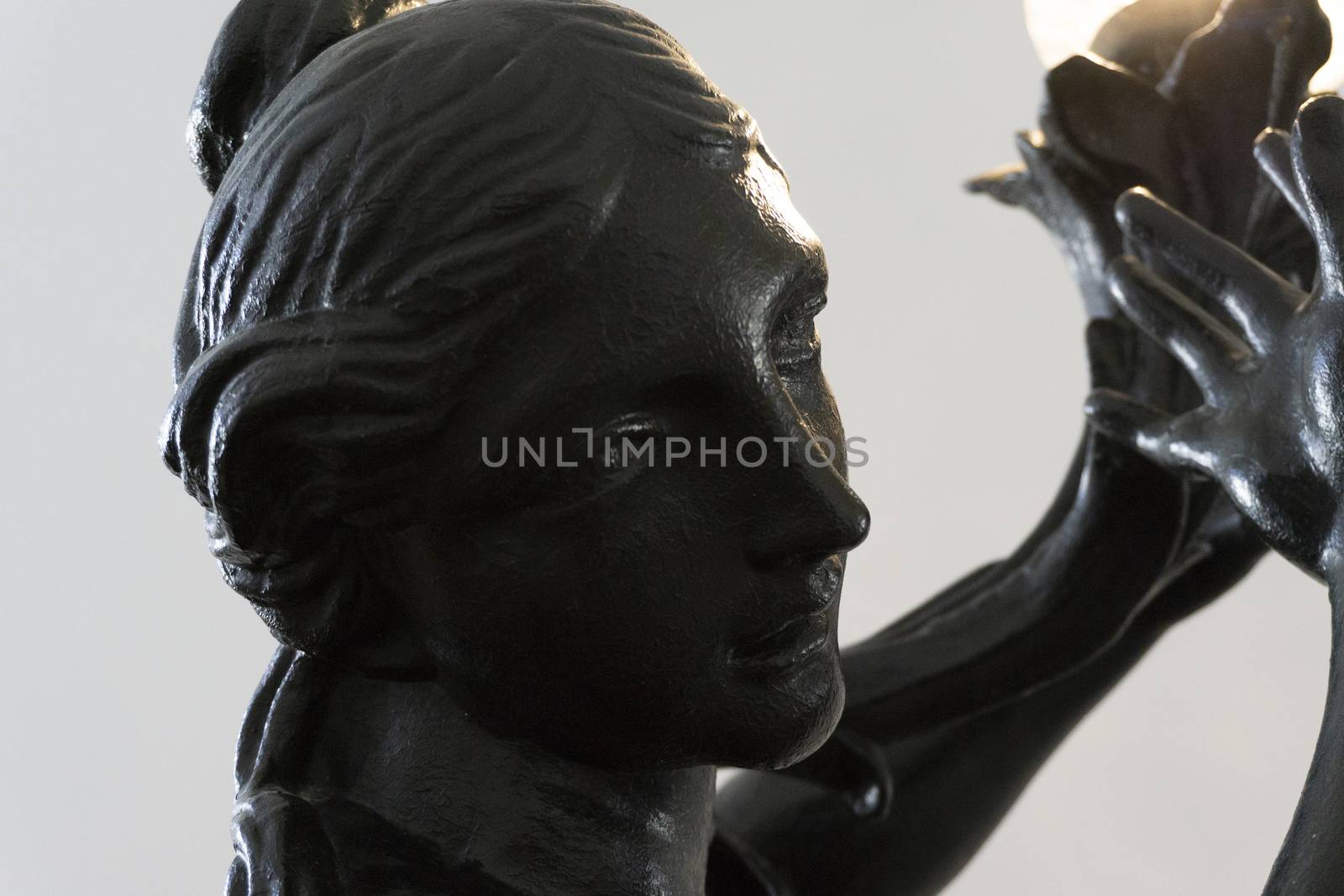 Carved steel statue of black color with the face of a Venus woman by lovecomunication