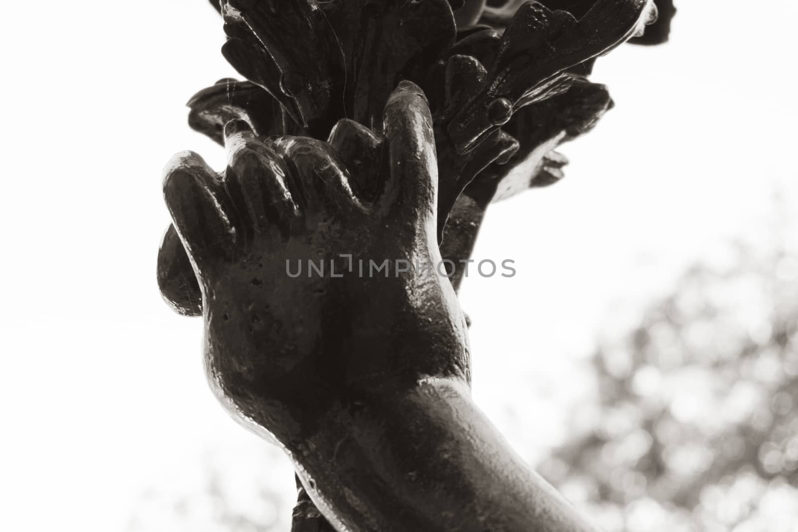 Detail on metal statue black . Hands detail