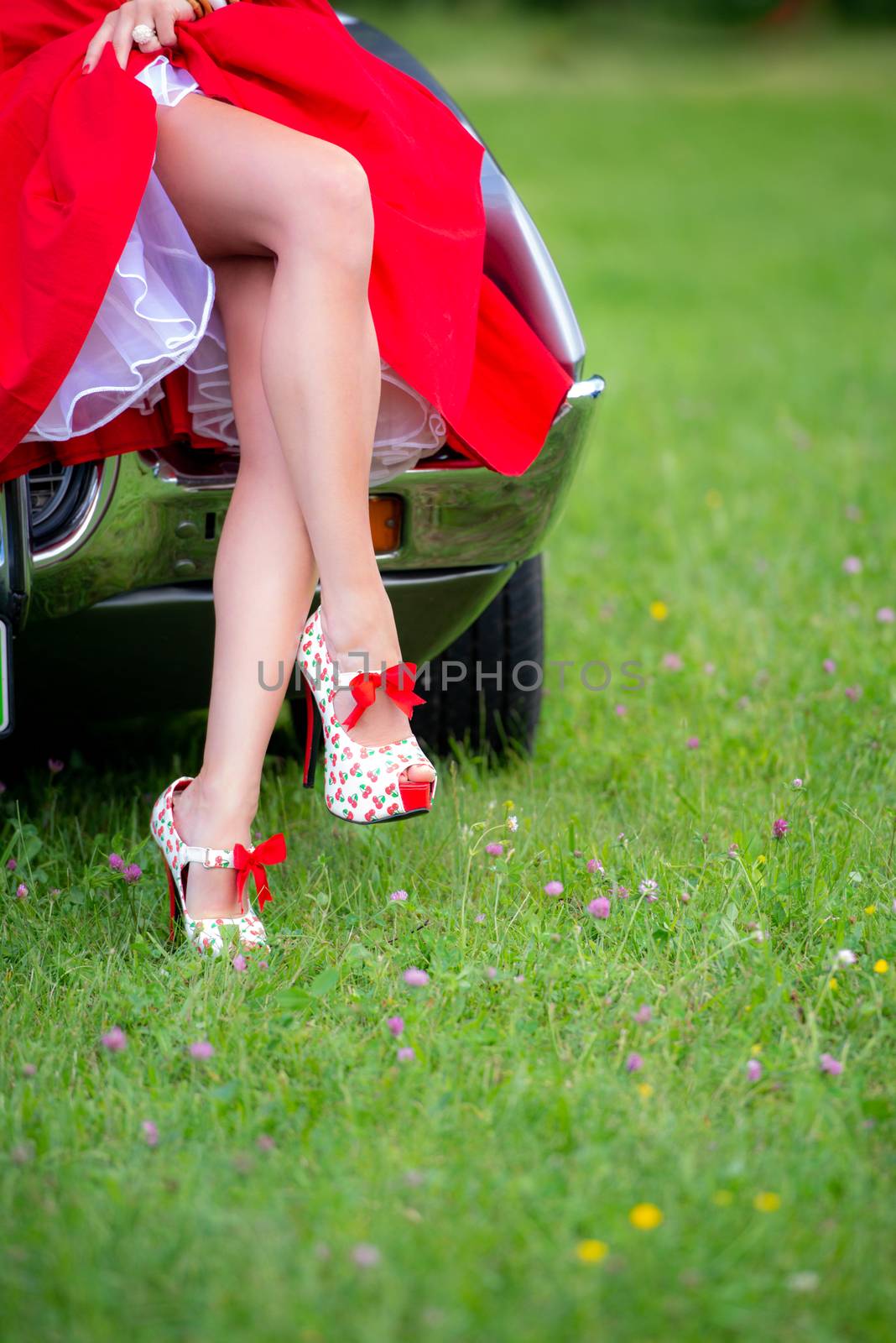 Pin Up Girl Style, young woman in red dress with long legs, wearing red high heels stilettos with cherries