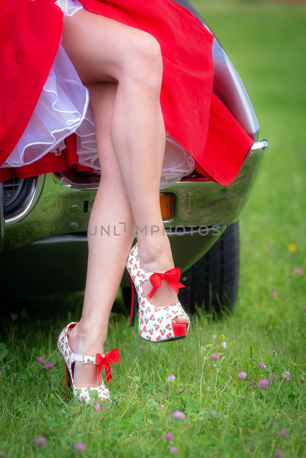 Pin Up Girl Style, young woman in red dress with long legs, wearing red high heels stilettos with cherries
