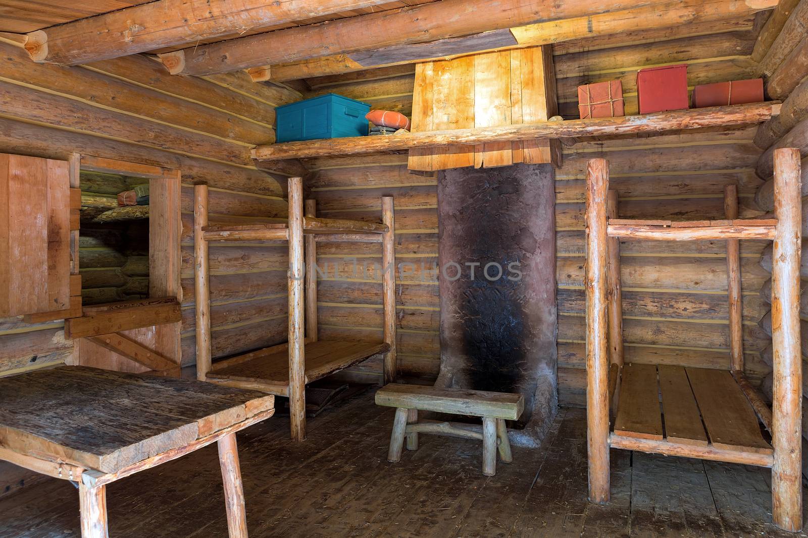 Fort Clatsop Log Cabin living quarters with bunk beds table and chair in Lewis and Clark Historical National State Park