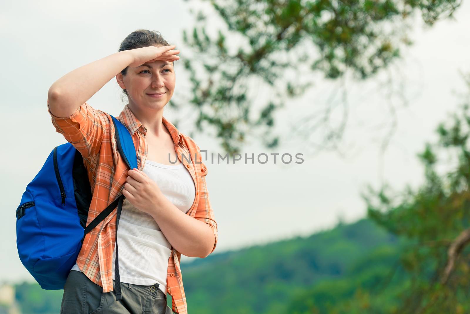 woman with a backpack on a weekend trip looking into the distance