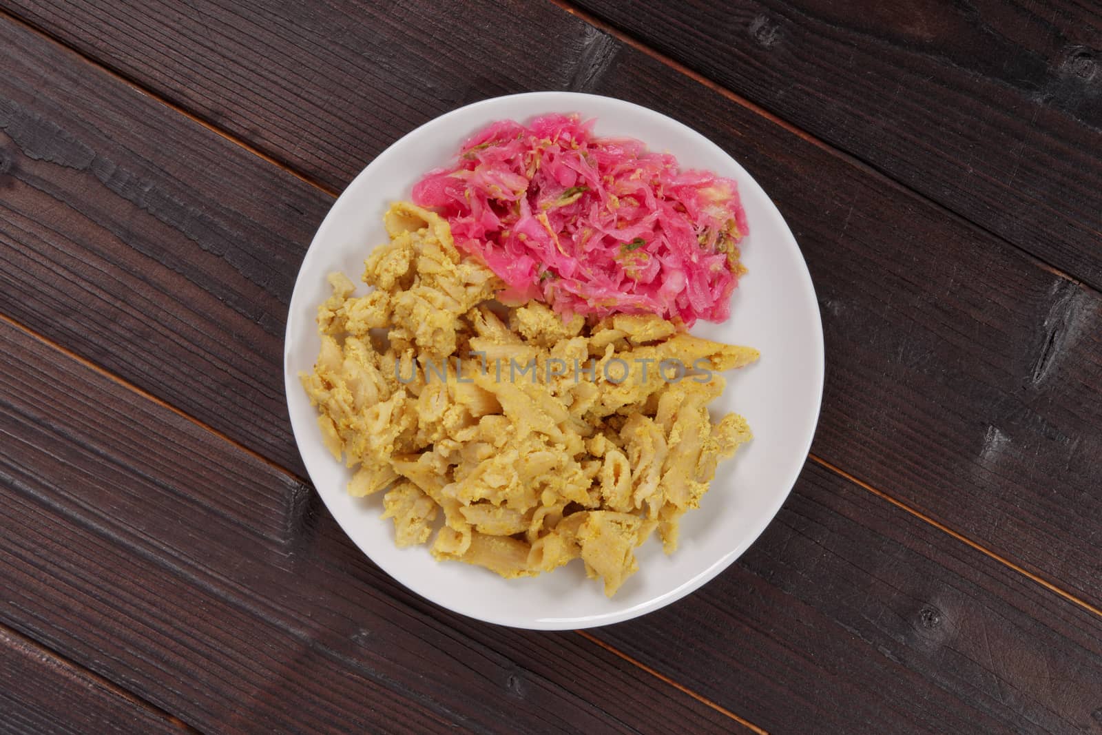 Whole-grain pasta with tofu on a wooden table