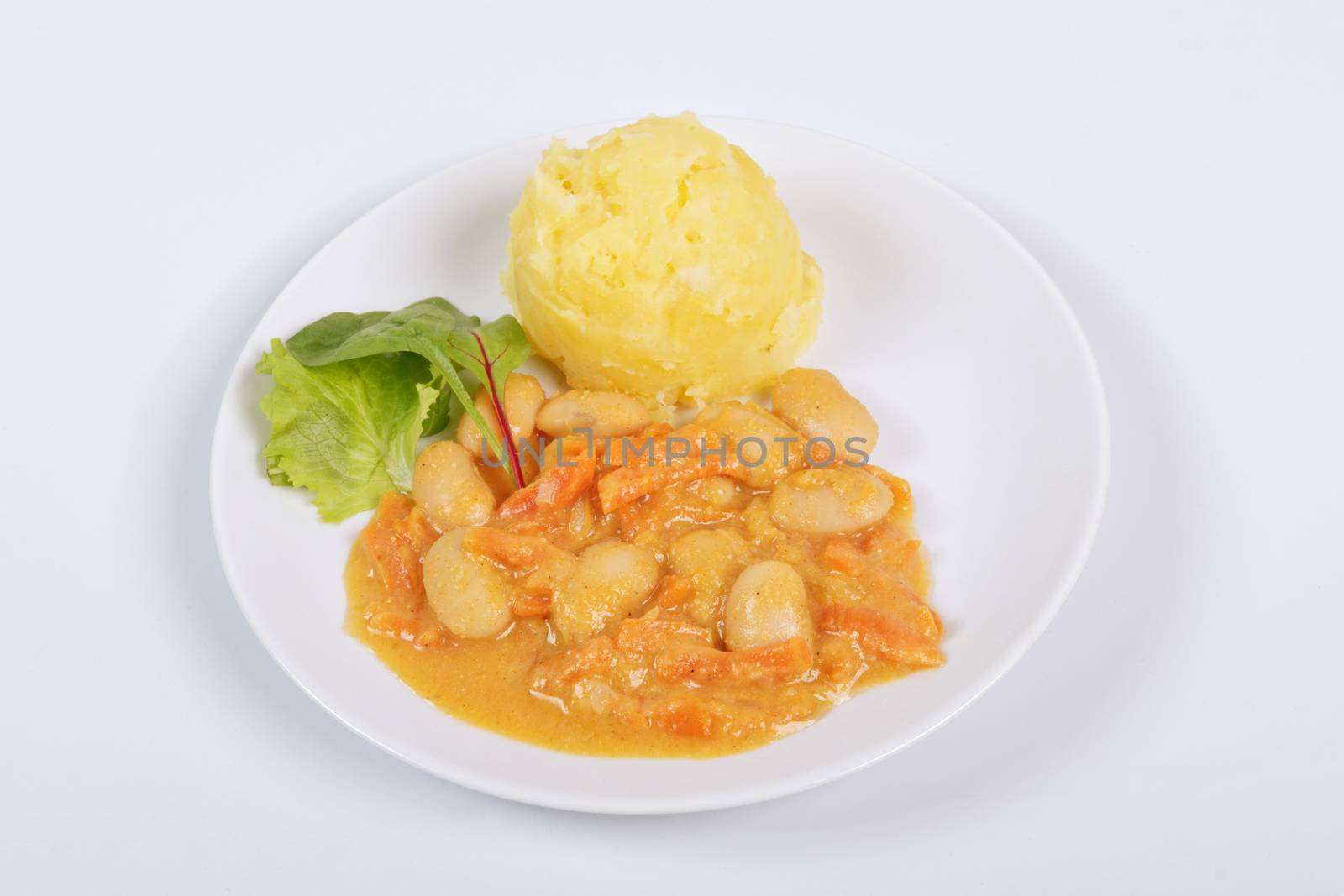 Beans with carrots and potatoes on a white background