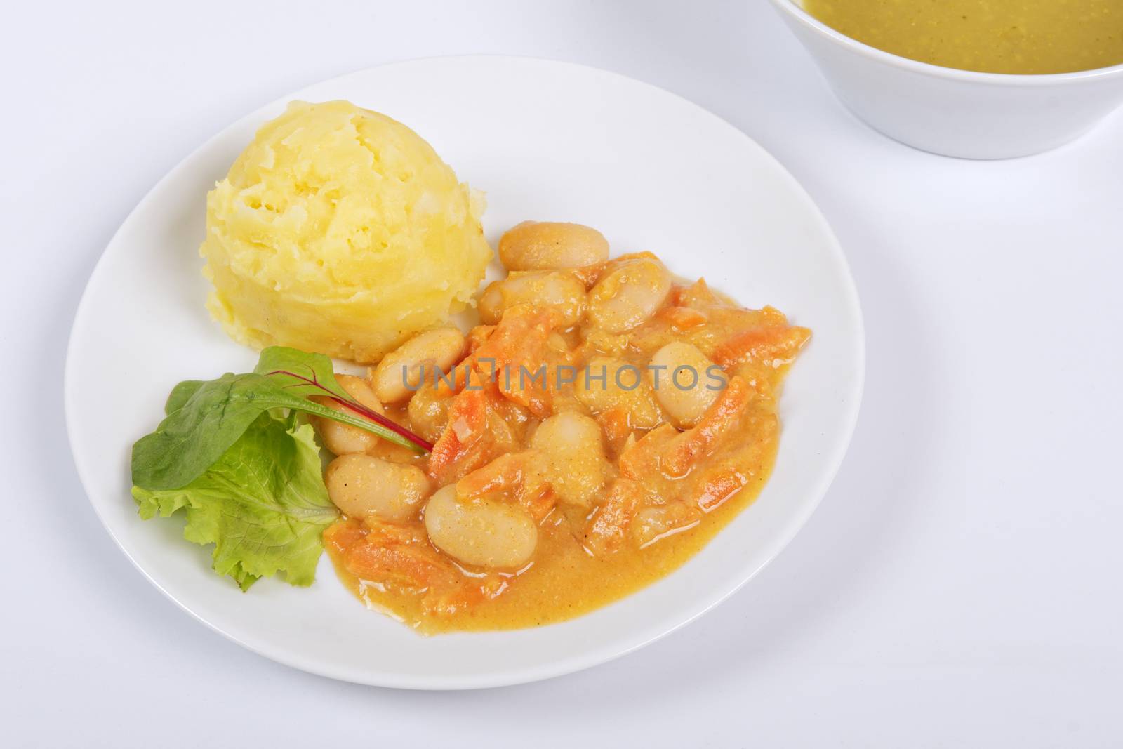 Beans with carrots and potatoes on a white background