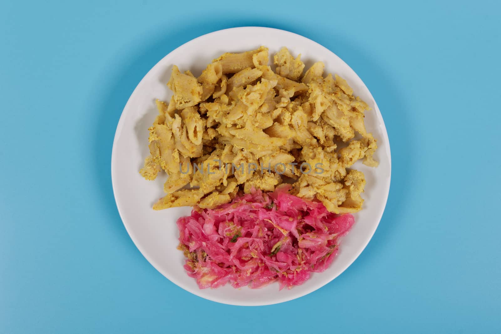 Whole-grain pasta with tofu on a blue background