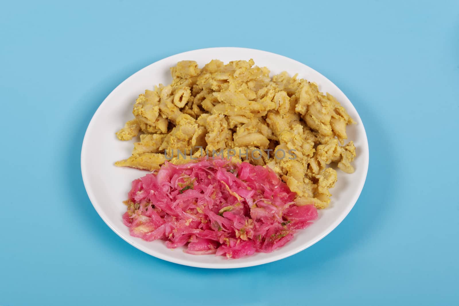 Whole-grain pasta with tofu on a blue background
