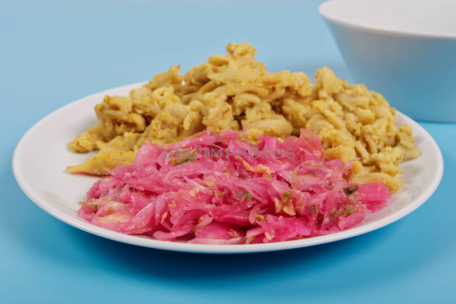 Whole-grain pasta with tofu on a blue background