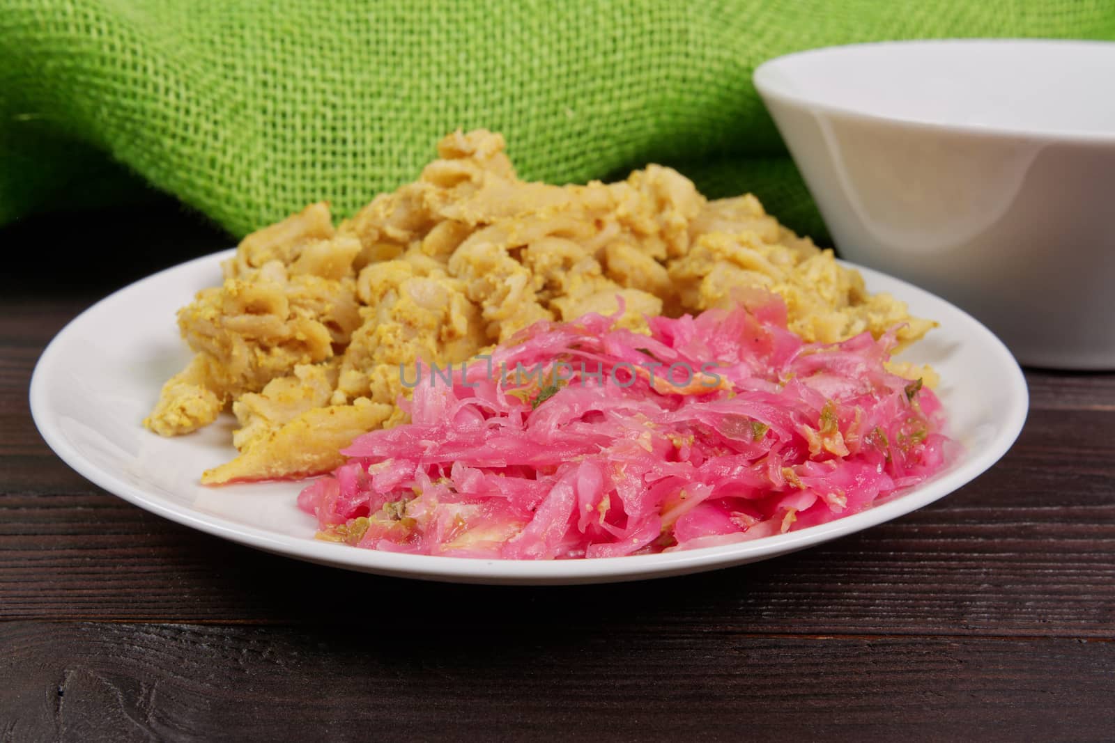 Whole-grain pasta with tofu on a wooden table