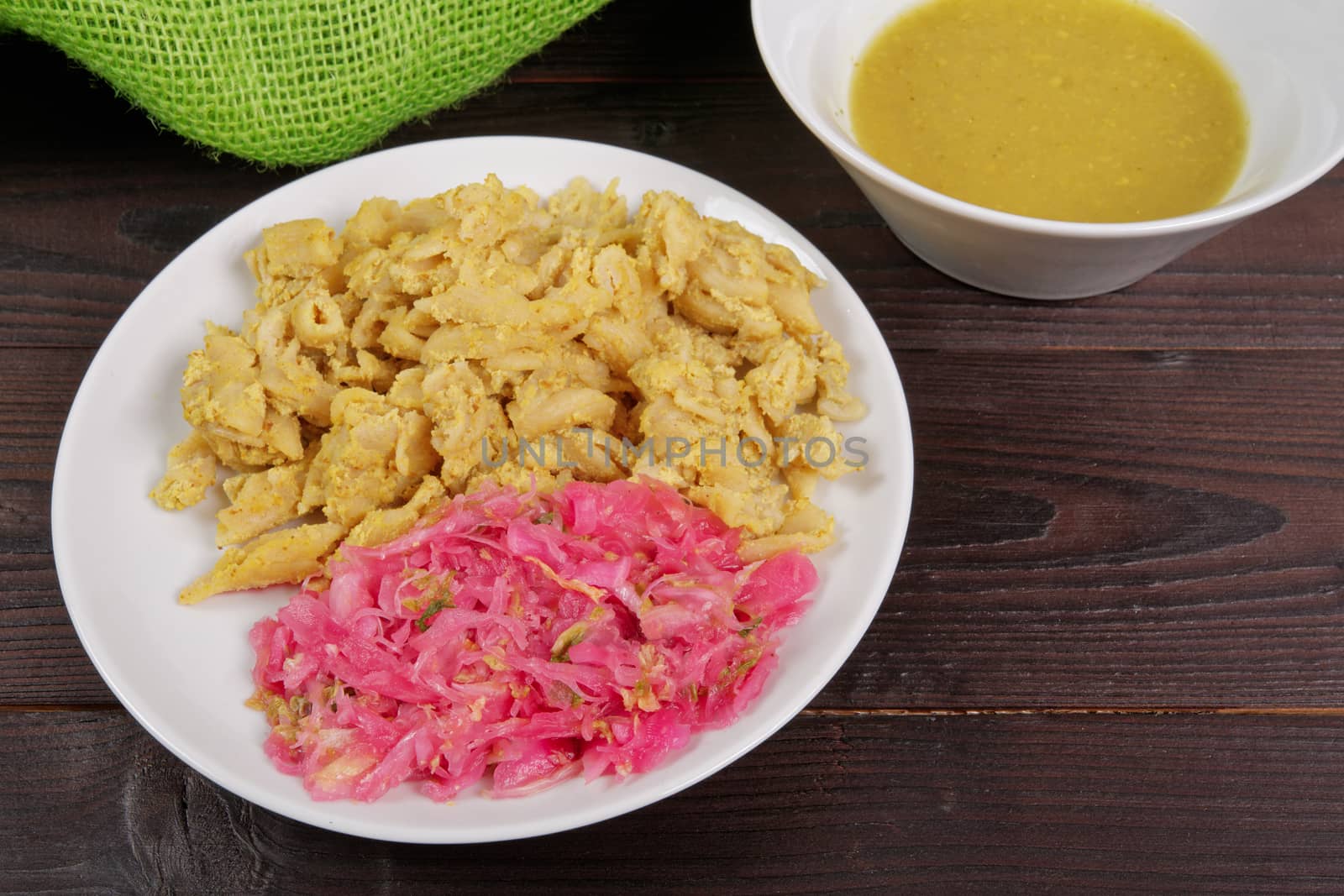 Whole-grain pasta with tofu on a wooden table