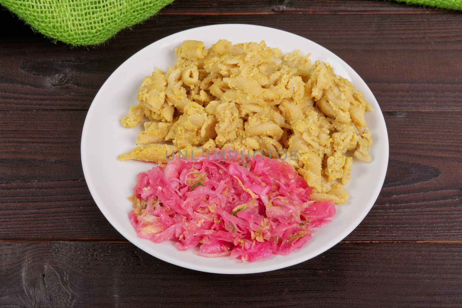 Whole-grain pasta with tofu on a wooden table