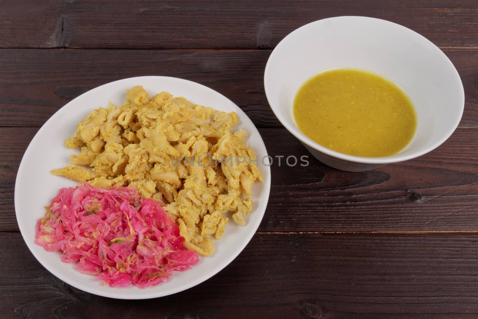 Whole-grain pasta with tofu on a wooden table